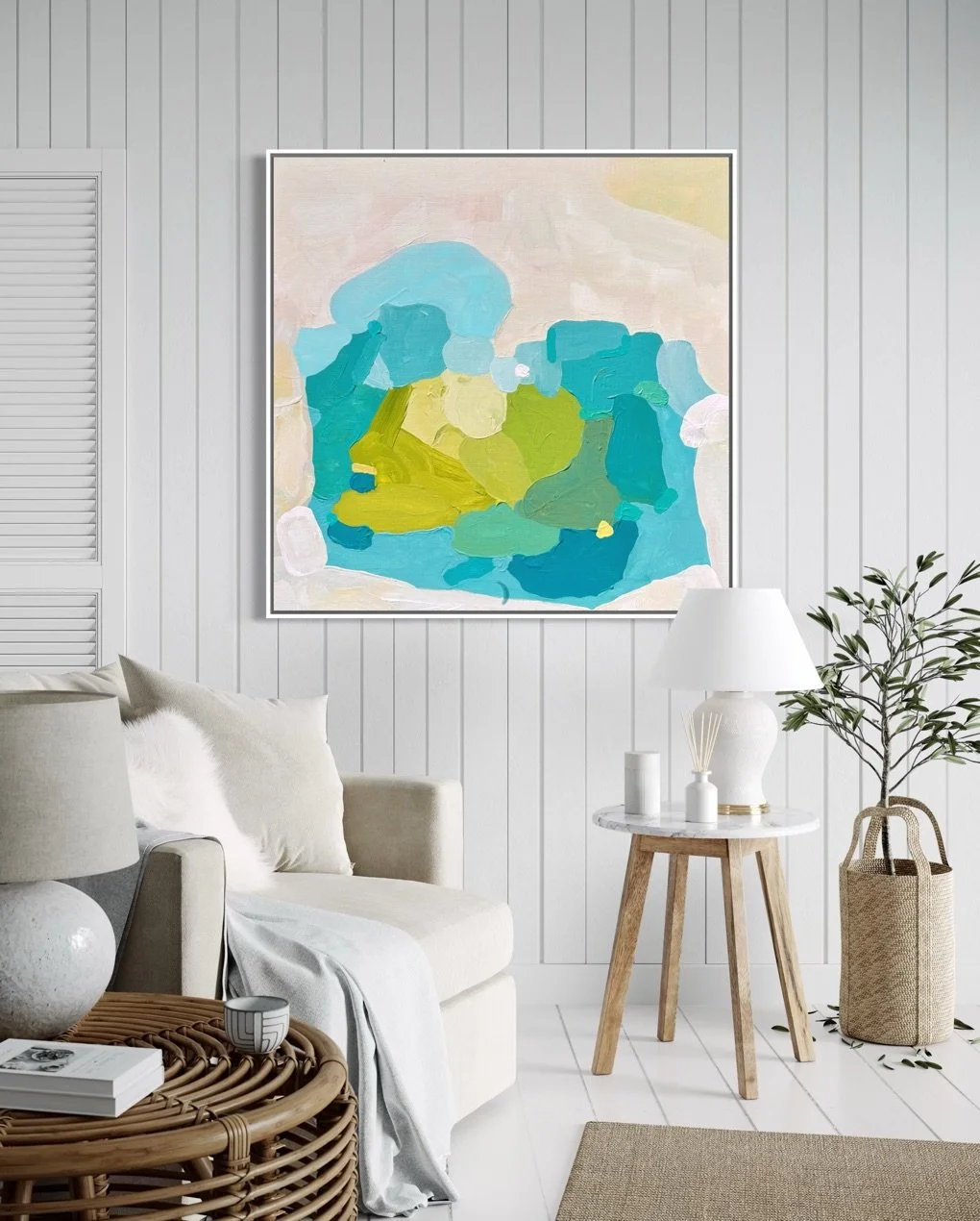 Bright coastal living room wall art Aquamarine Muse by Birgit Trofer hanging above a cozy cream couch with natural fabrics and green plants.