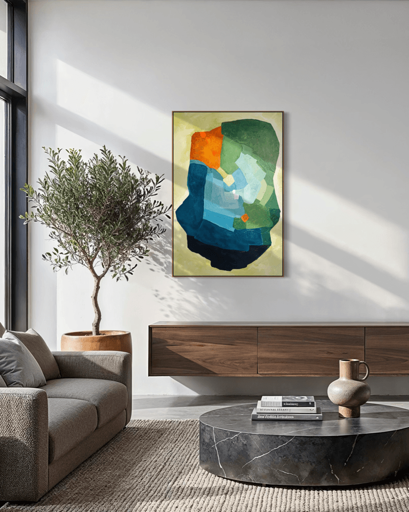Balancing Friction – original, abstract artwork by Birgit Trofer. Contemporary artwork exploring the dynamic tension in blue, green and vibrant orange accents, mounted on a light wall in a modern exclusive living room.