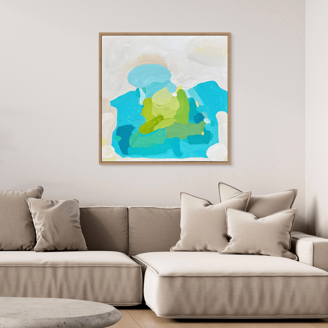 Contemporary art inspired by the coast and the ocean, by Birgit Trofer, styled  in a cozy living room above a beige sofa.