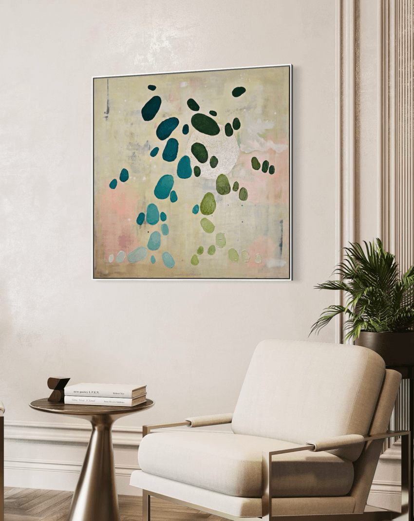 Painting from the series Dancing Palette by Austrian artist Birgit Trofer mounted on a beige elegant wall of a waiting are with a comfortable lounge chair.