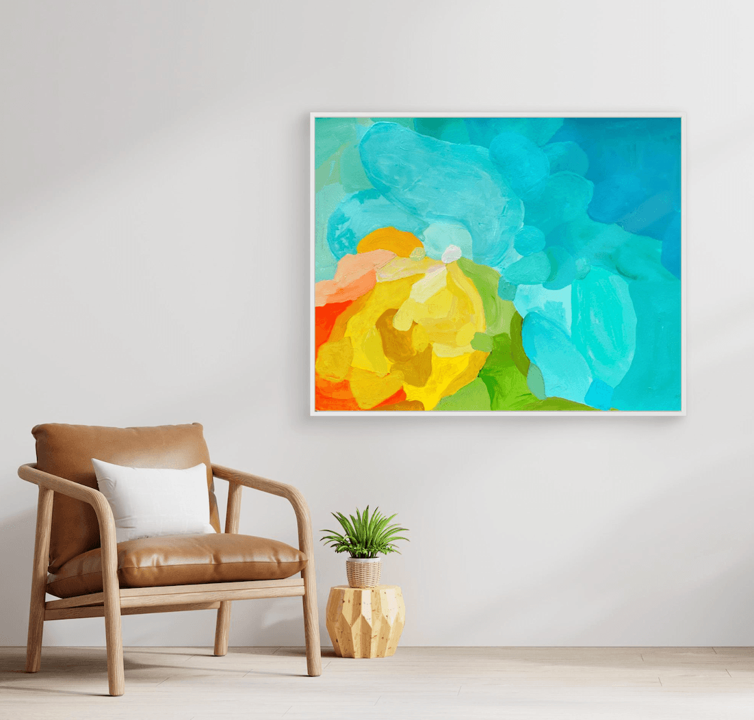 Sophisticated abstract painting Shoreline Clarity by Birgit Trofer in a white floating frame, styled in a minimalist waiting room next to a luxury brown leather chair.