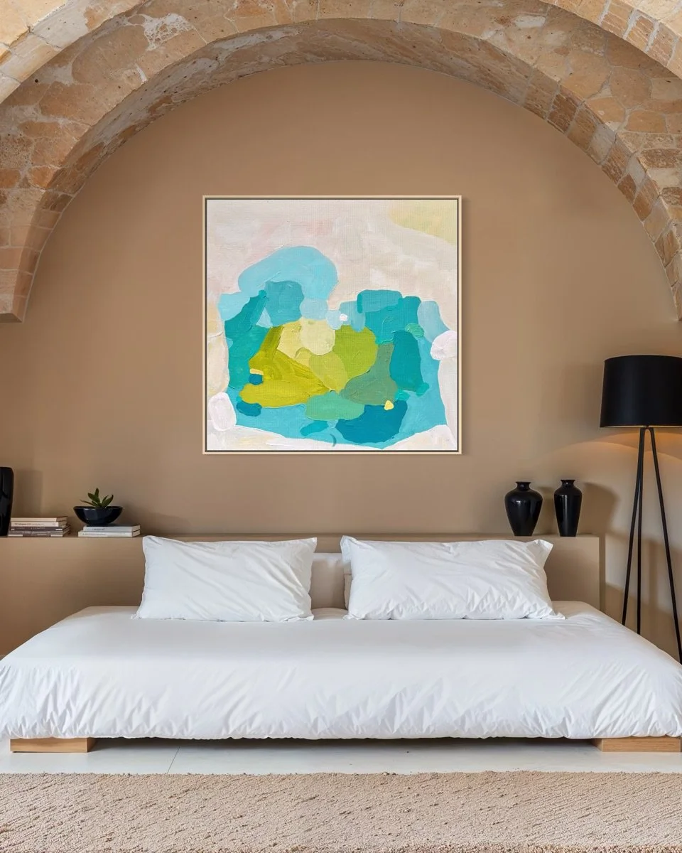 Luxury bedroom decor Aquamarine Muse by Austrian artist Birgit Trofer featured on a warm brown wall with a sandstone arch above a bed with crisp white linen.