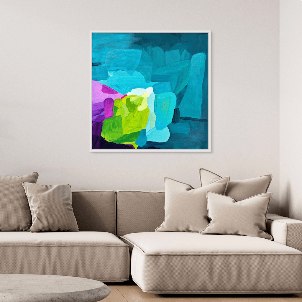 Elegant abstract painting Deep Swell by Birgit Trofer in a white floating frame, styled above a soft sofa with bright, cozy pillows, highlighting the fresh lime green and violet tones.