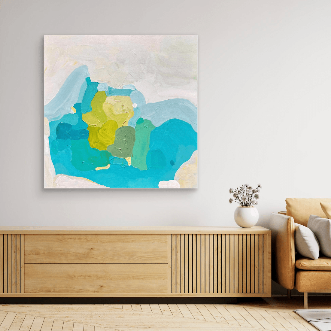 Fine art print on canvas in neutral living room mounted on wall, above a wooden shelf besides a beige sofa.