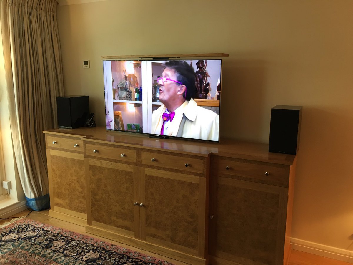 Rising TV intergrated into custom cabinet