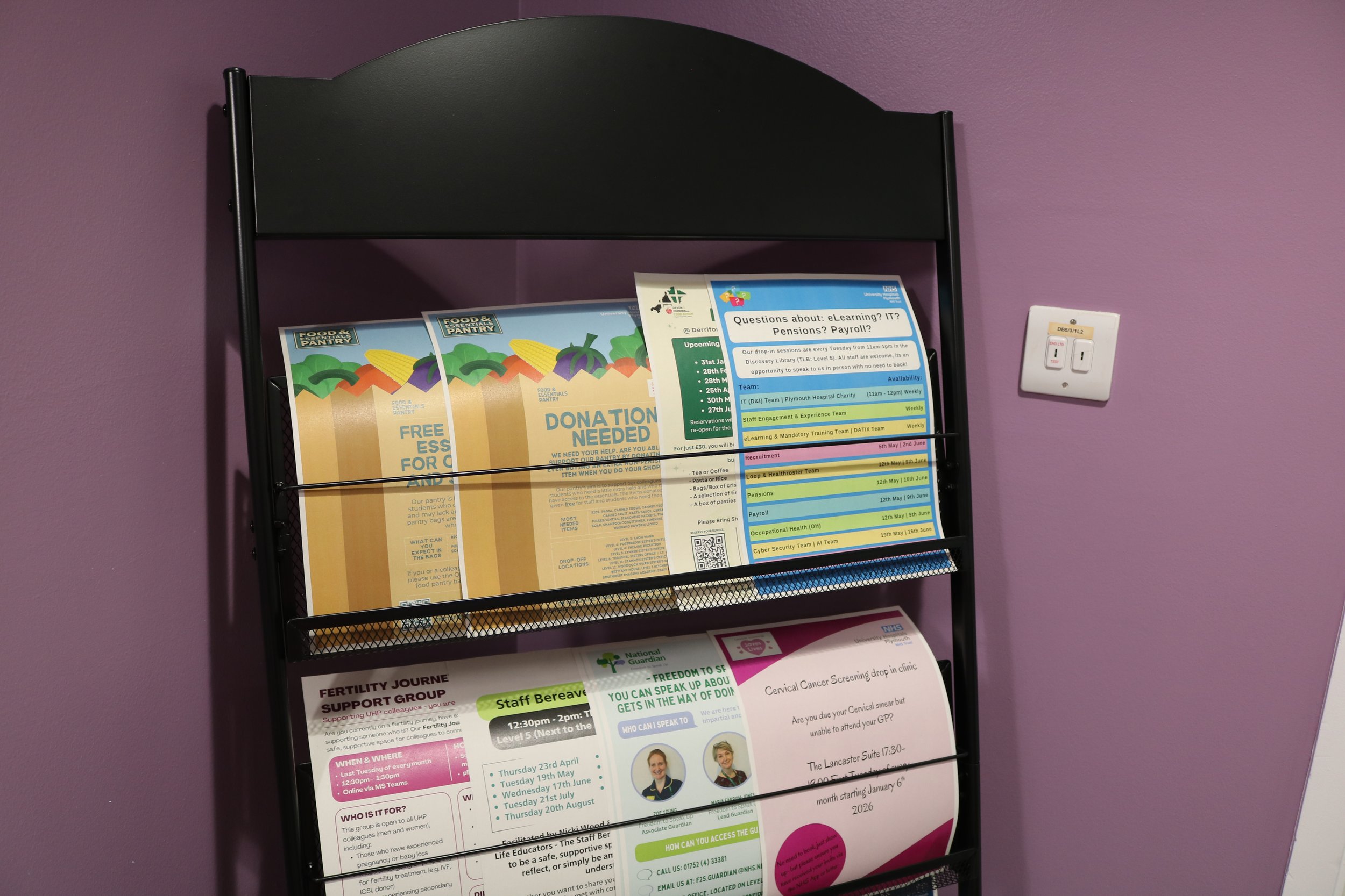  Close up image of information stand with printed support materials inside for staff 