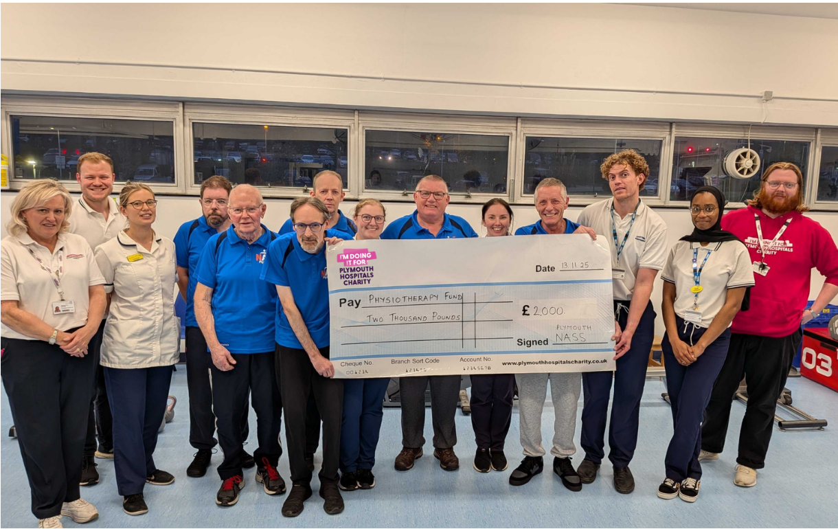 Plymouth NASS group holding a giant cheque with the Physiotherapy team.