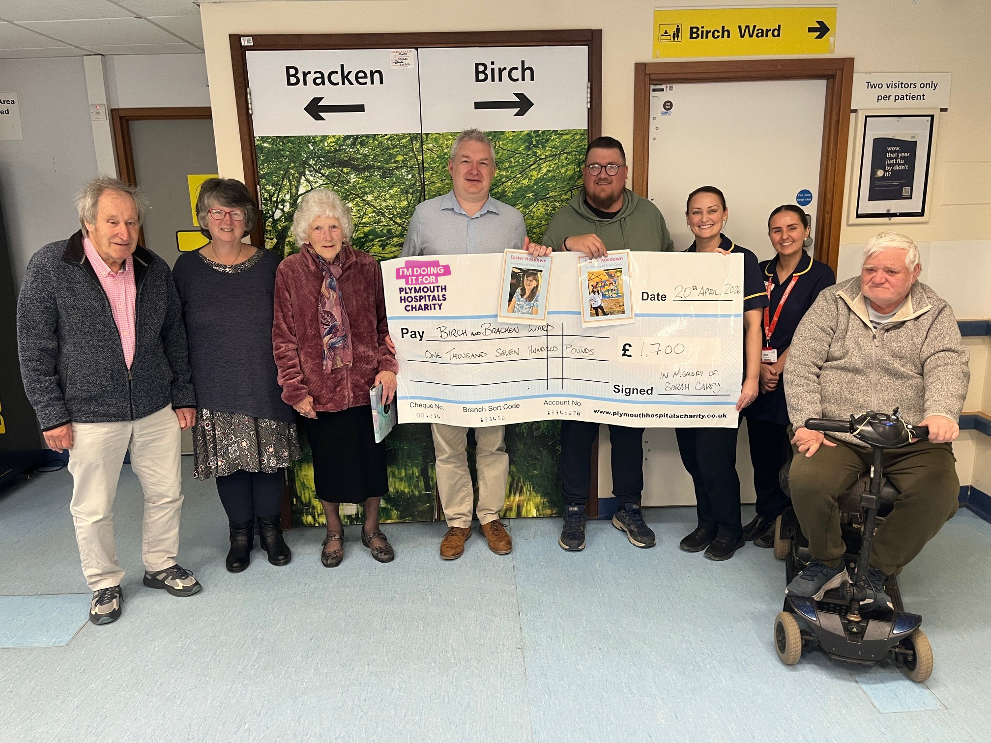 Sarah’s family presenting the cheque to staff from Birch and Bracken.