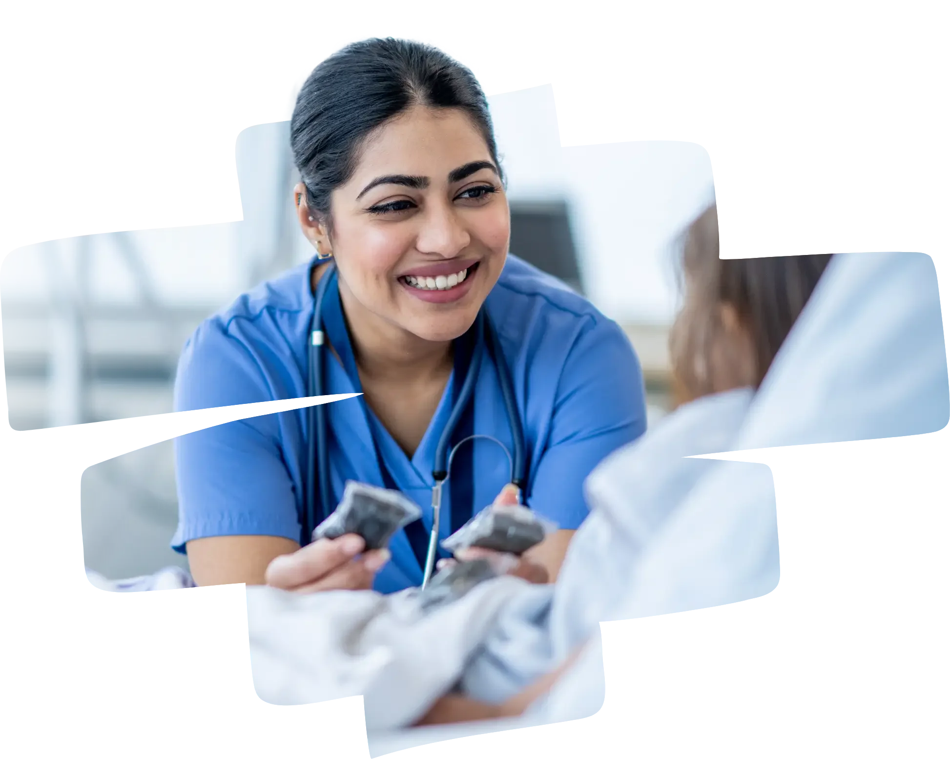 Nurse smiling and talking to a patient in a hospital room
