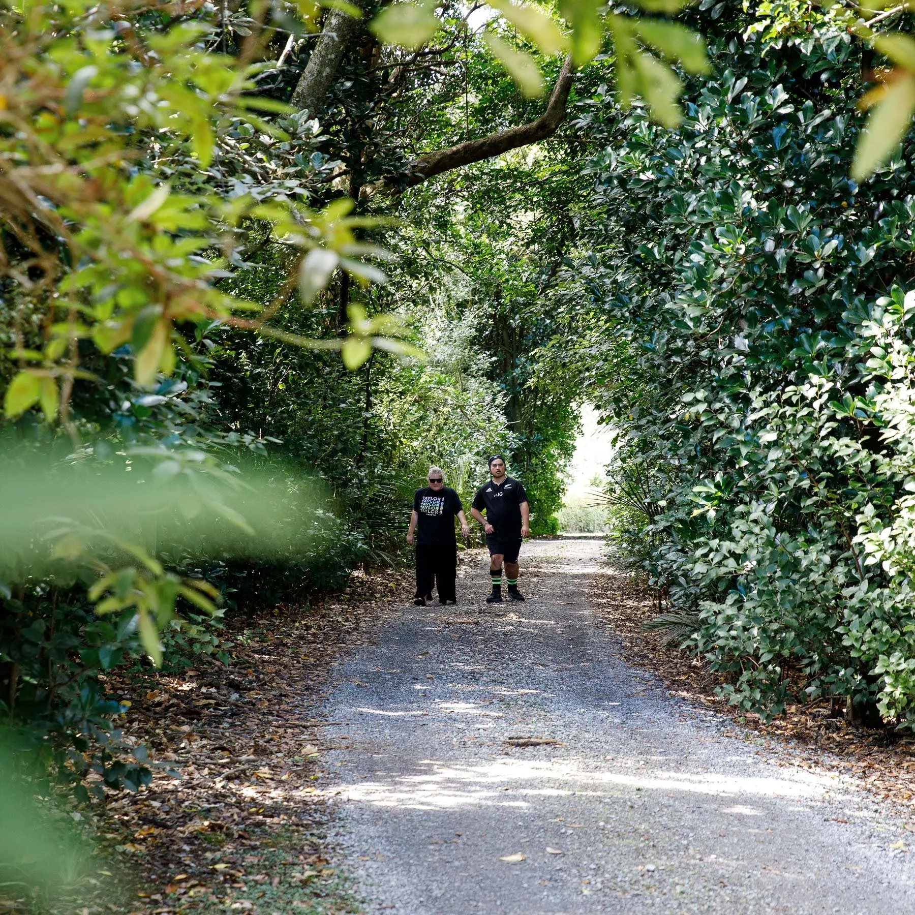 Solway Vision support worker and resident walking down driveway in rural setting