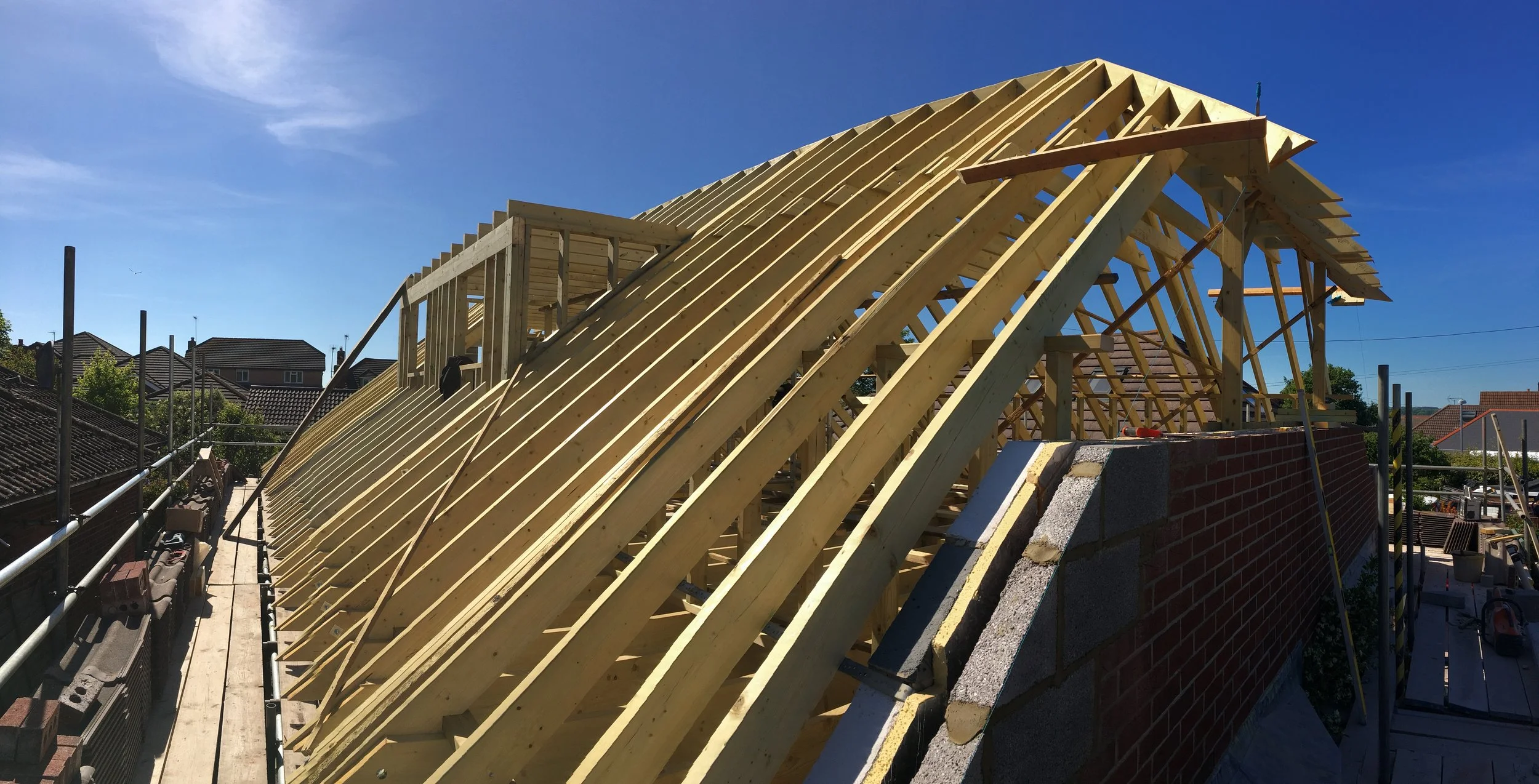 Under construction roof with wooden framing on a building.
