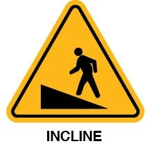 Yellow warning sign with a silhouette of a person walking down an incline and the word 'Incline' underneath.