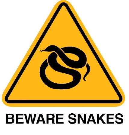 Yellow warning sign with a black snake symbol and the text "BEWARE SNAKES" underneath.