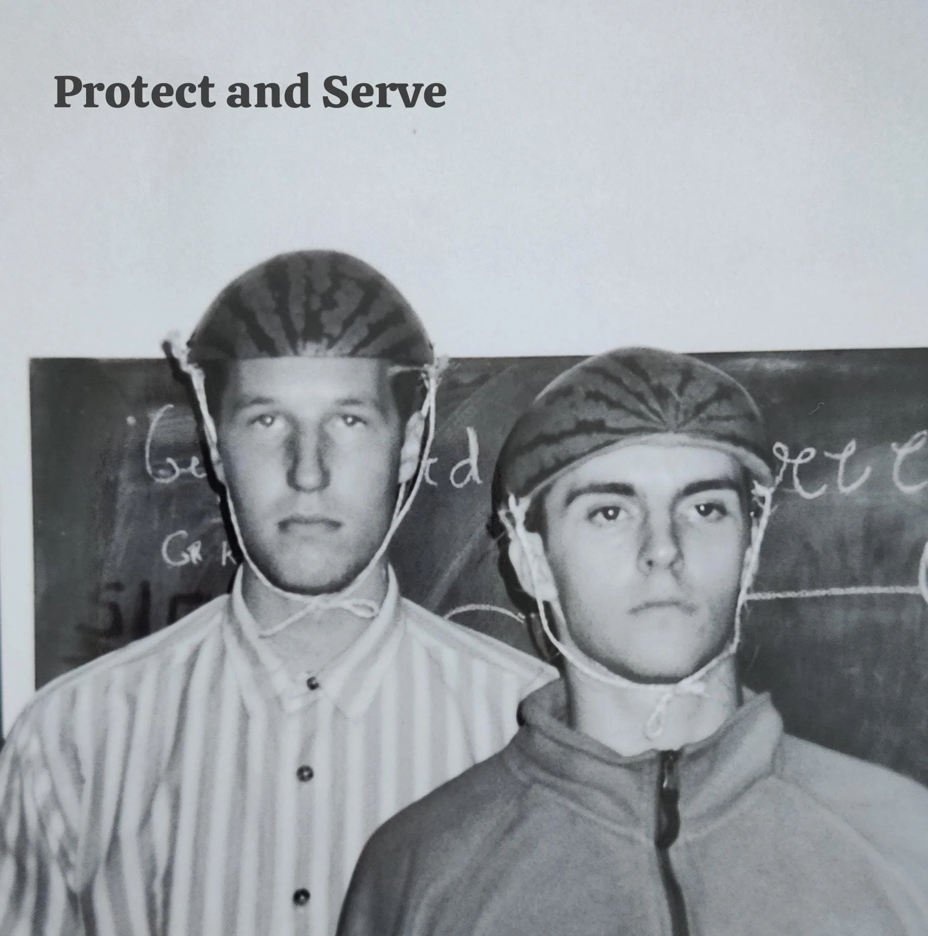 Black and white photo of two young men with serious expressions, wearing helmets, standing in front of a chalkboard with writing on it. The photo has cut-out faces. Text at the top says "Protect and Serve."
