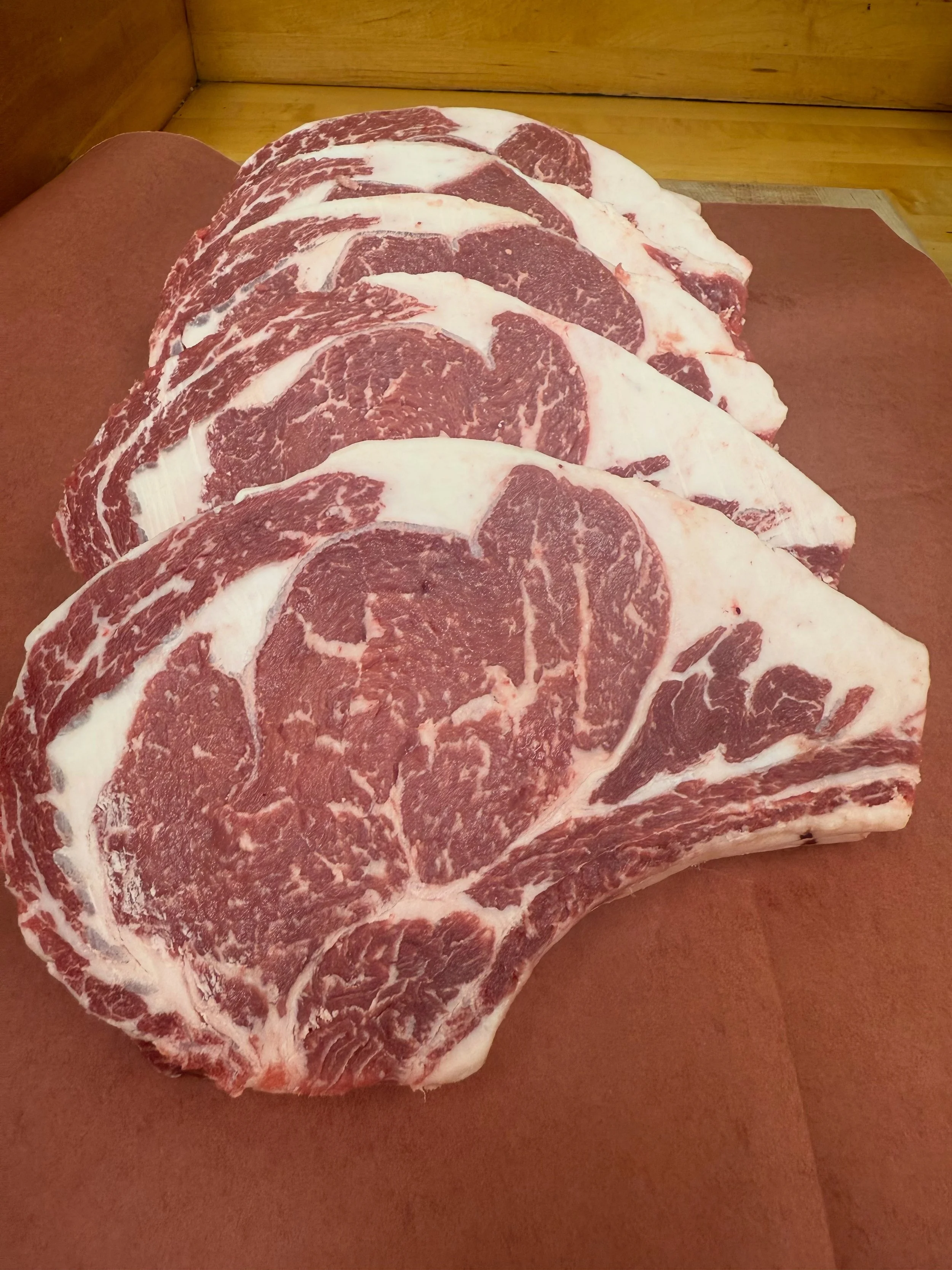 Marbled ribeye cuts in butcher shop.