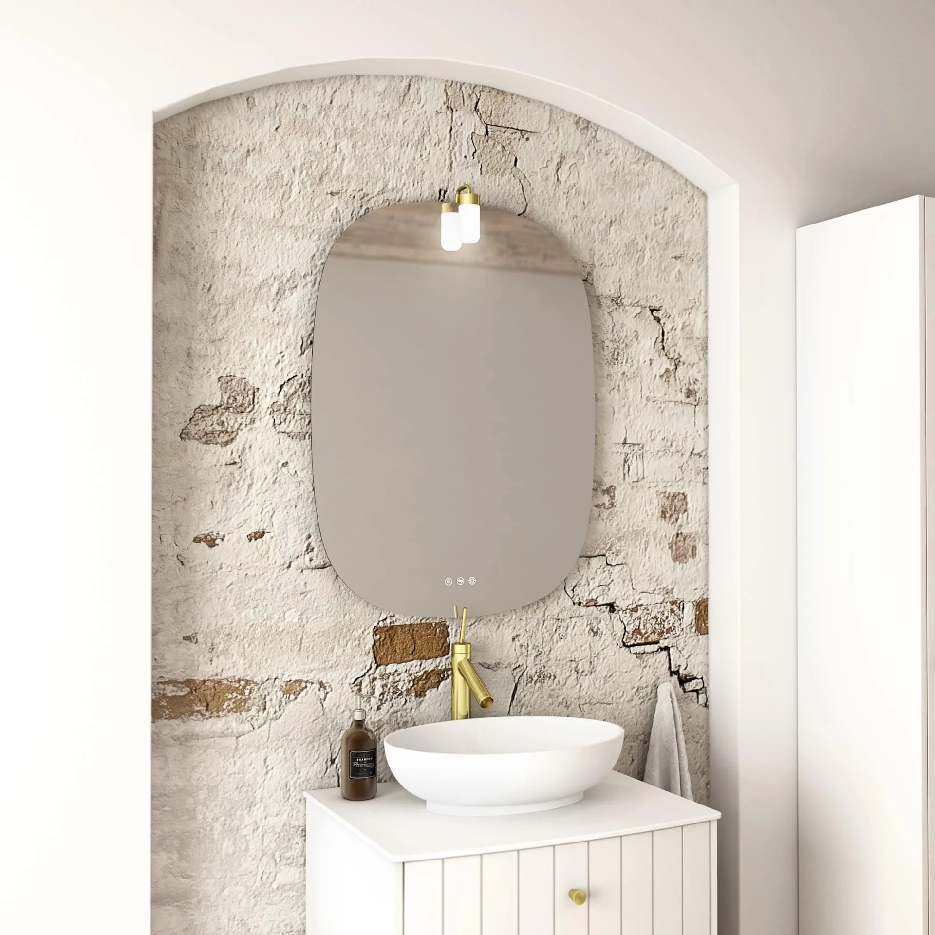 Modern meets rustic bathroom vanity with a white vessel sink, a small brown soap dispenser, a large oval mirror, and a textured stone wall with a gold faucet.