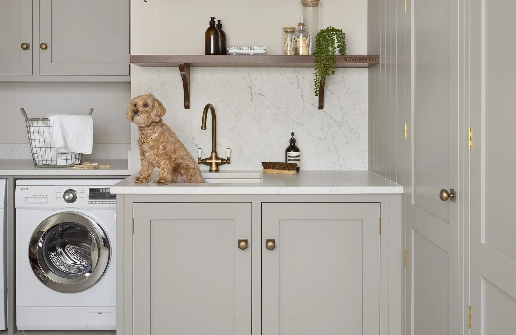 trendy natural utility room with brass handles
