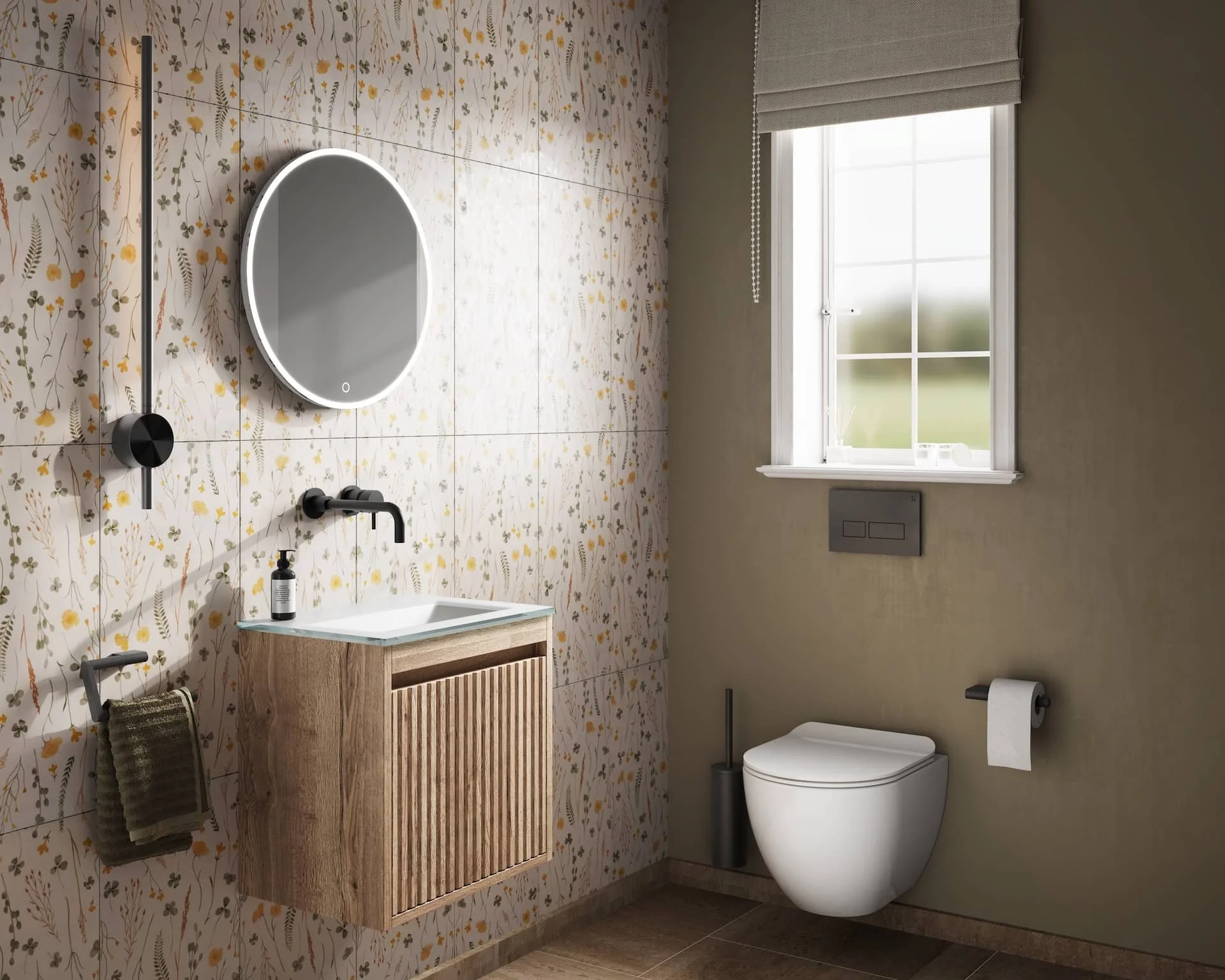 Modern bathroom with floral wallpaper, a round mirror with built-in lighting above a small wooden vanity with a white sink, black fixtures, a dark green towel hanging, a toilet with a dual-flush system and toilet paper holder, a black toilet brush, and a window with a blind allowing natural light.