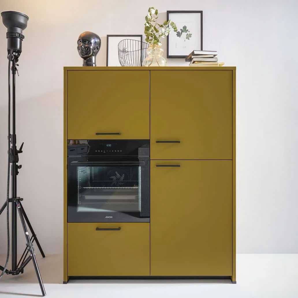Olive green kitchen cabinet with built-in black oven, placed against a plain white wall.