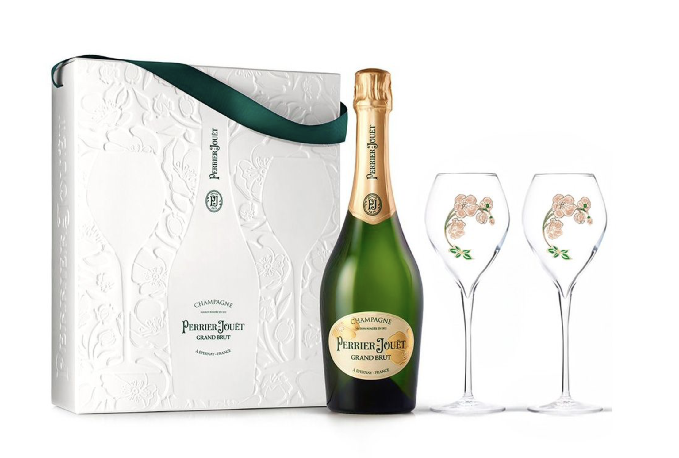 Botella de champán Perrier-Jouet Grand Brut junto a dos copas decoradas con flores, y caja de regalo blanca con grabados florales