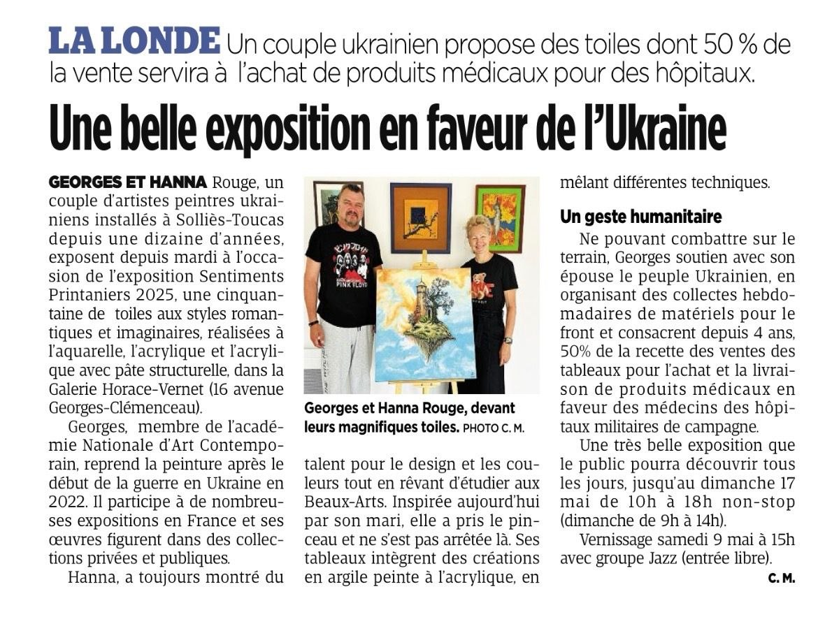 Photo of Georges and Hanna Rouge standing in front of an art exhibition with their paintings displayed on the wall behind them.