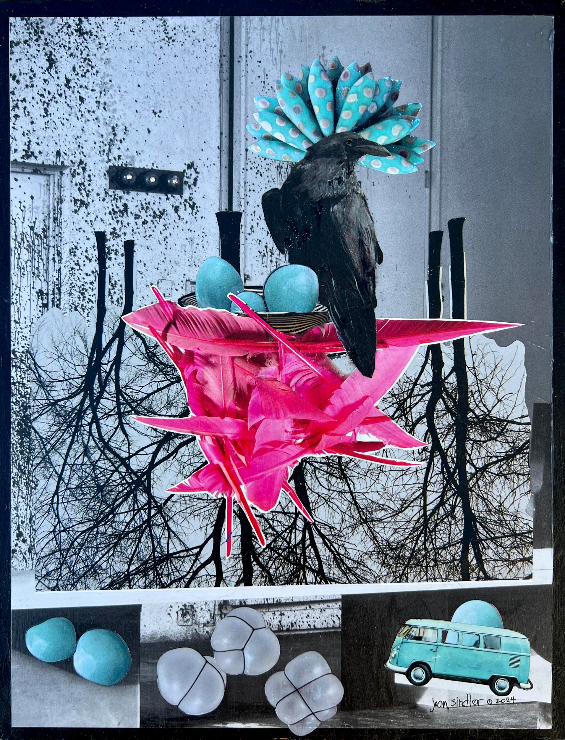 Mixed-media art display featuring a black bird, pink and blue paper flowers, light blue eggs, white marbles, and a vintage light blue van model, with a background of snowy trees and a gray building.