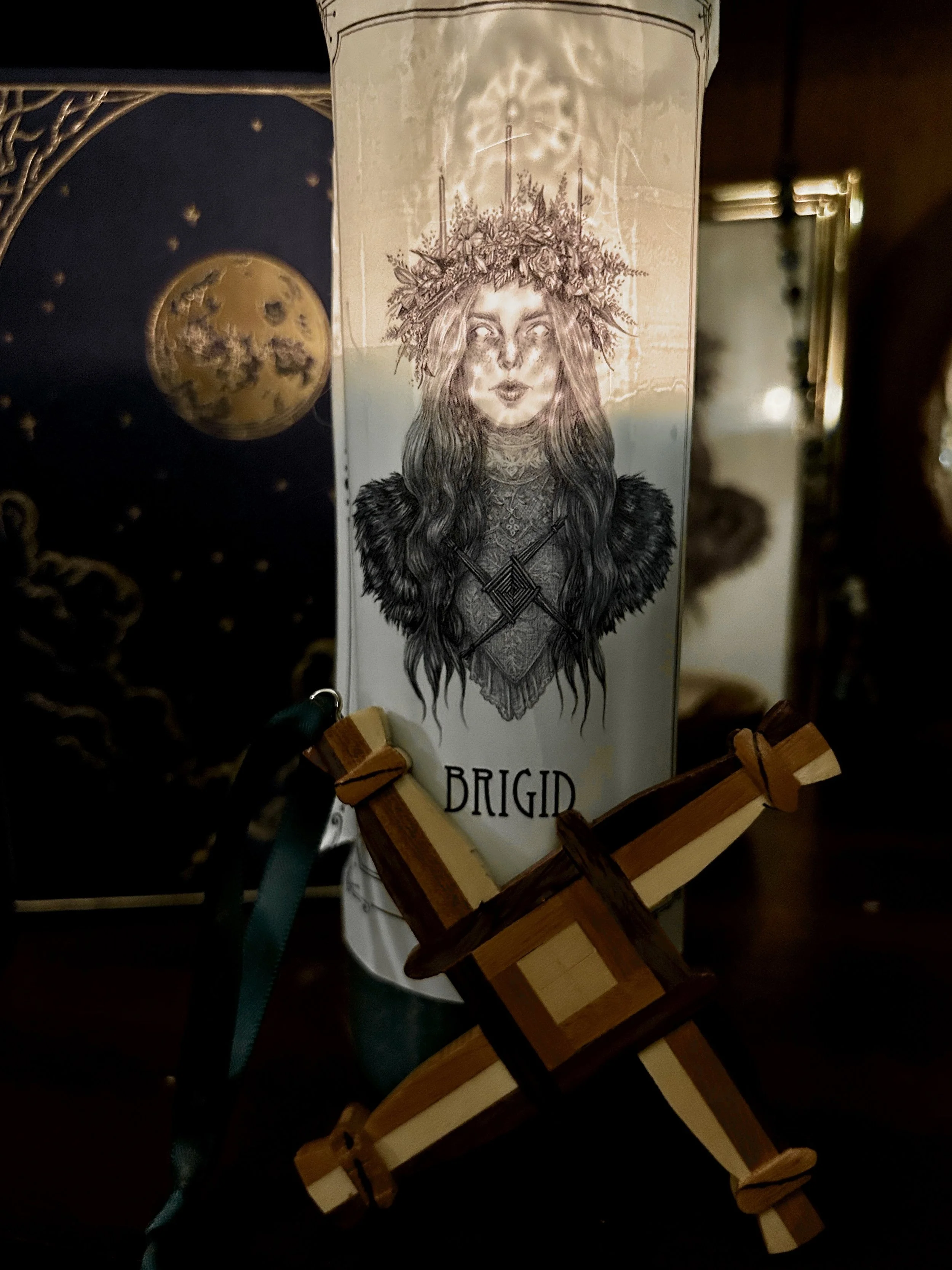 A lit candle representing Saint Brigid, glowing softly against a simple background.