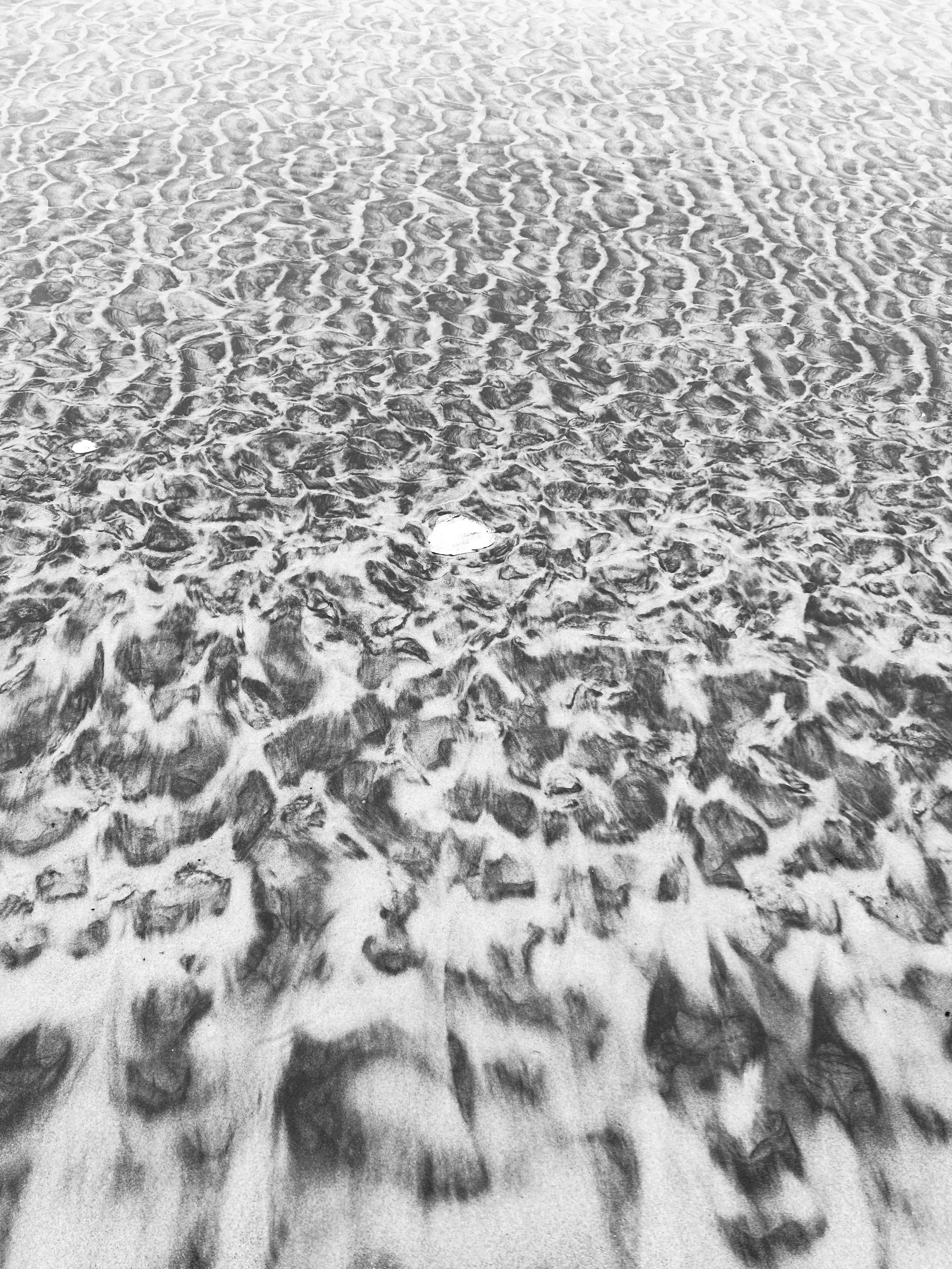 rippled sand patterns lightly covered with snow