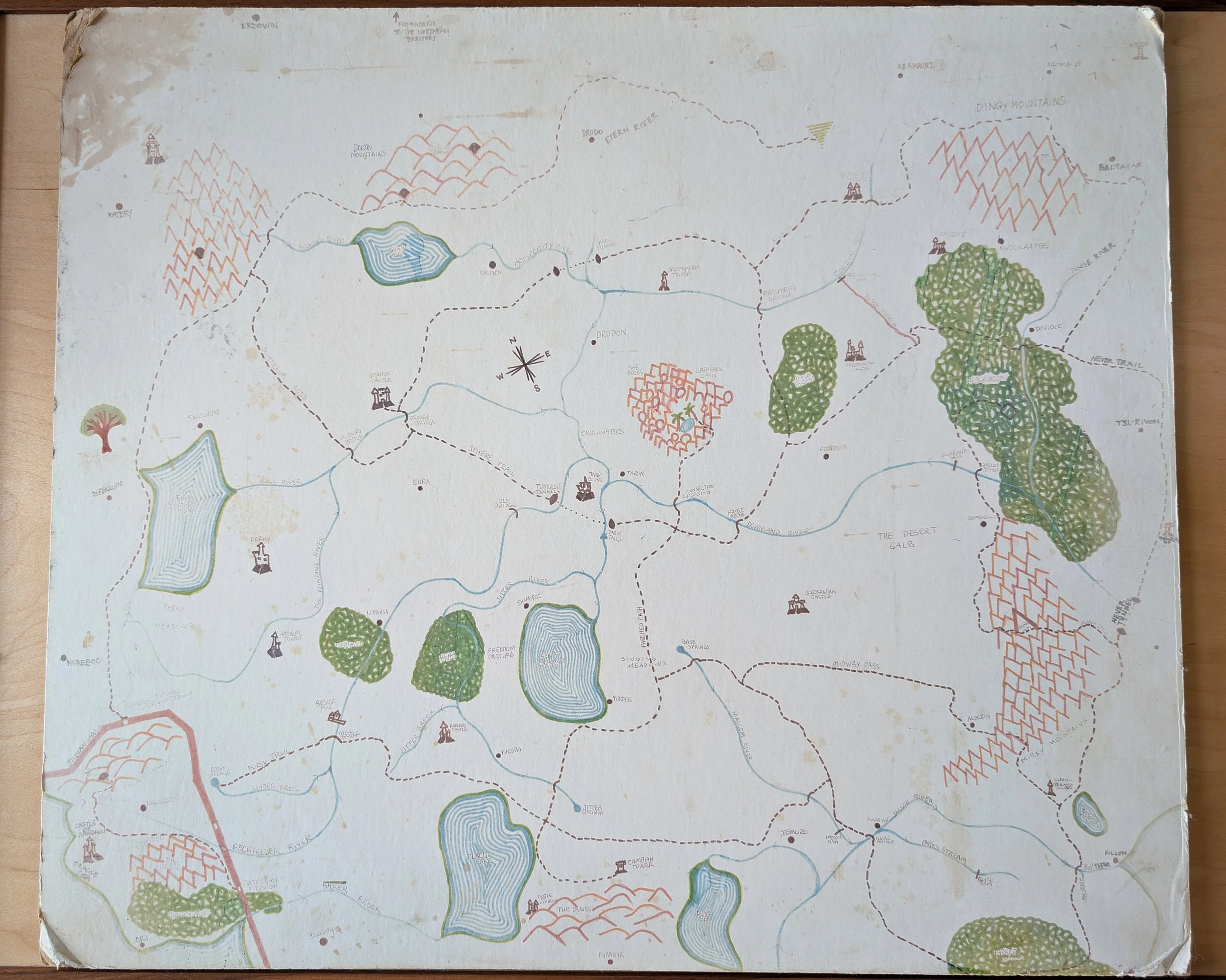 A hand-drawn, vintage-style map showing rivers, lakes, hills, forests, and pathways.