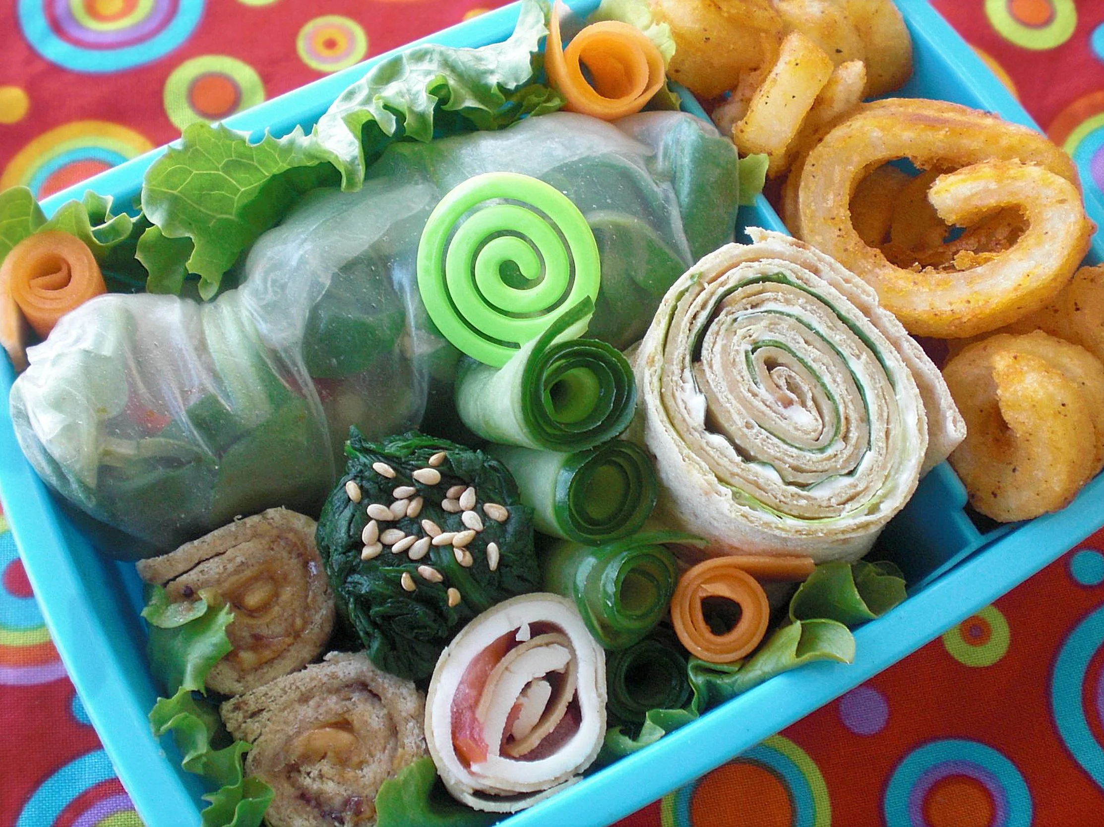 A blue bento box filled with neatly arranged food