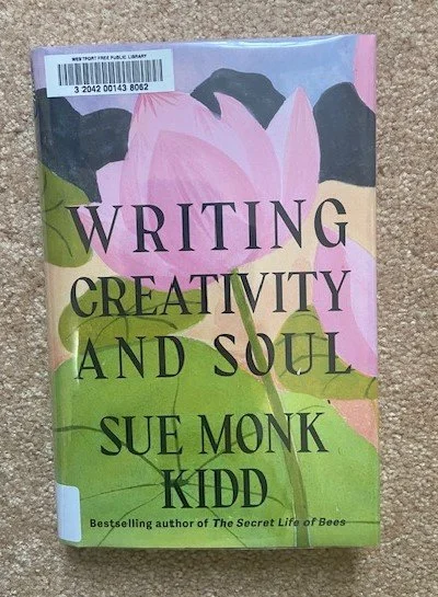A book titled “Writing Creativity and Soul” by Sue Monk Kidd with a floral cover.