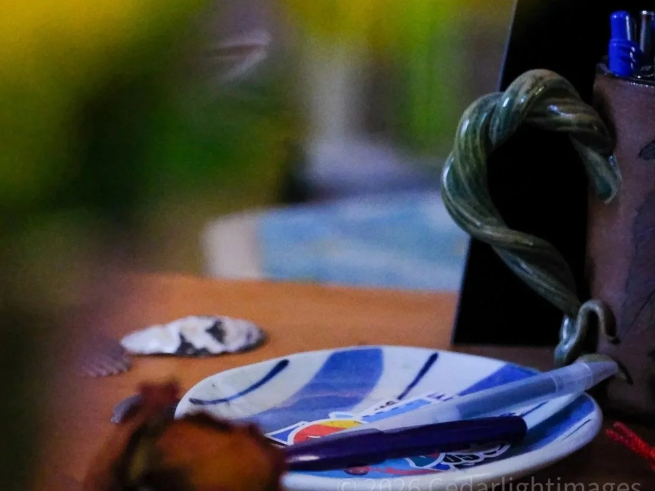 A writing workspace with pens and art supplies on a table