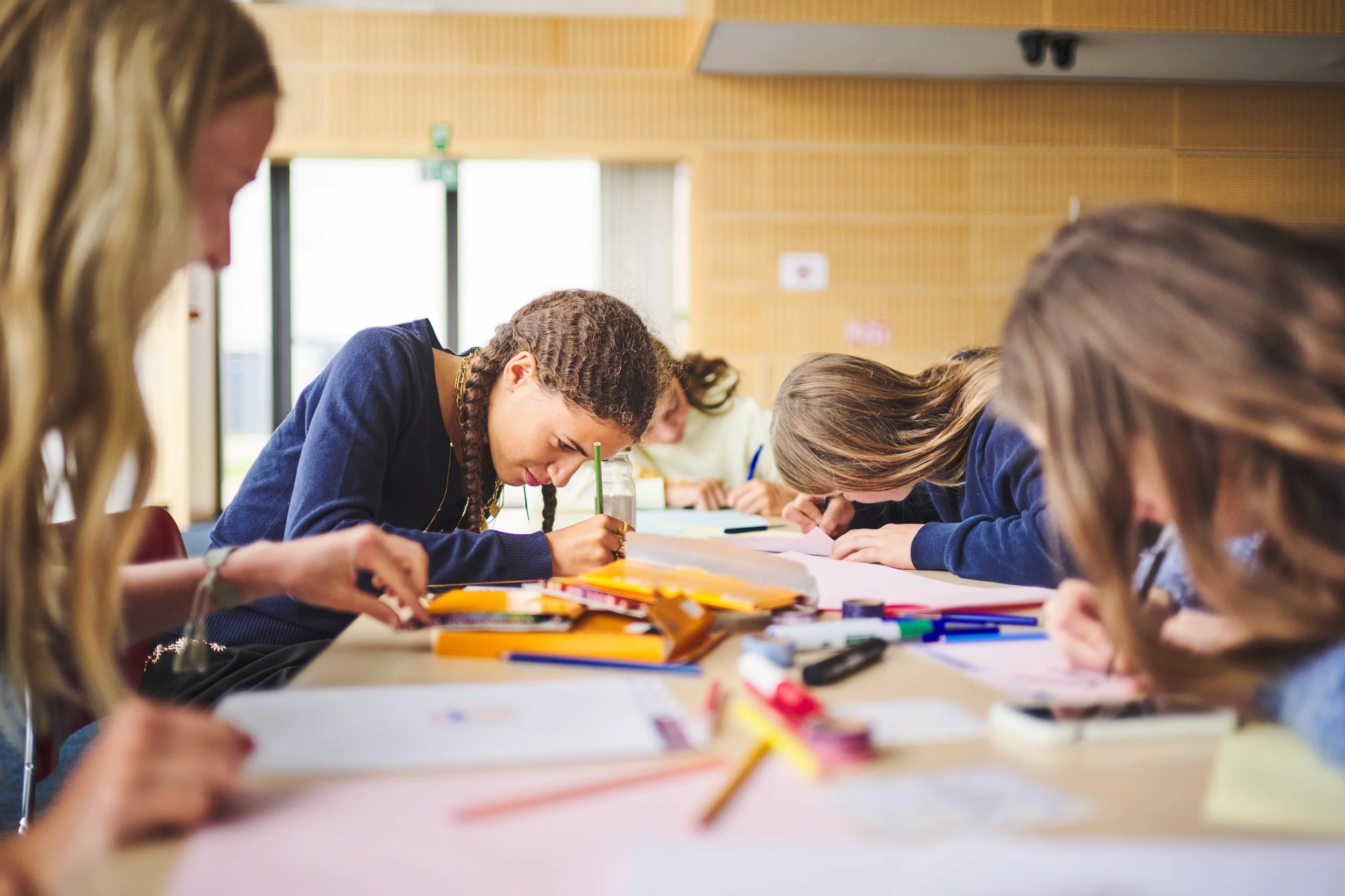 Two girls are colouring.