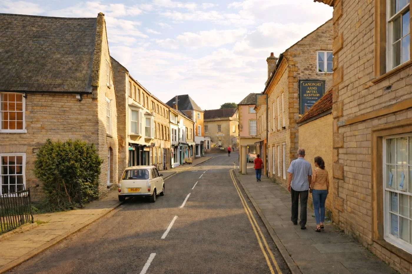 Langport town street view with stone buildings and people walking