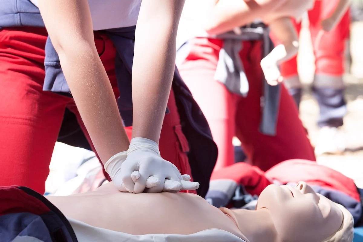 midsection-paramedic-performing-cpr-dummy-outdoors.jpg