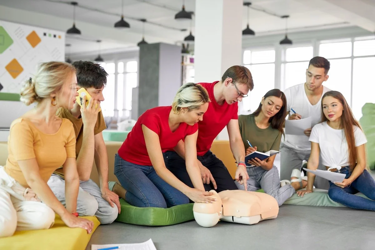 cpr-class-with-young-instructors-demonstrating-help-first-aid.jpg
