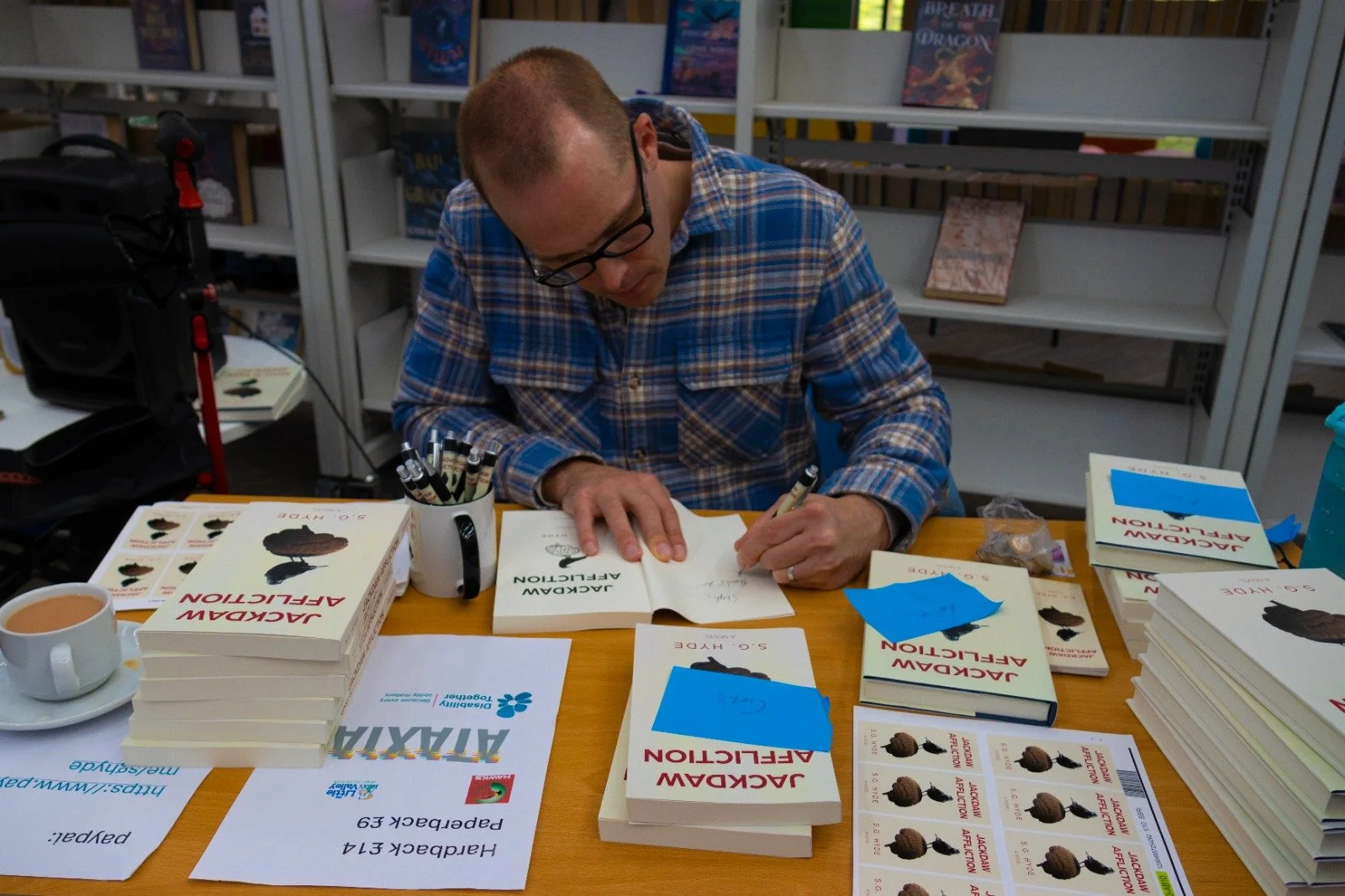 Me signing books at my book launch
