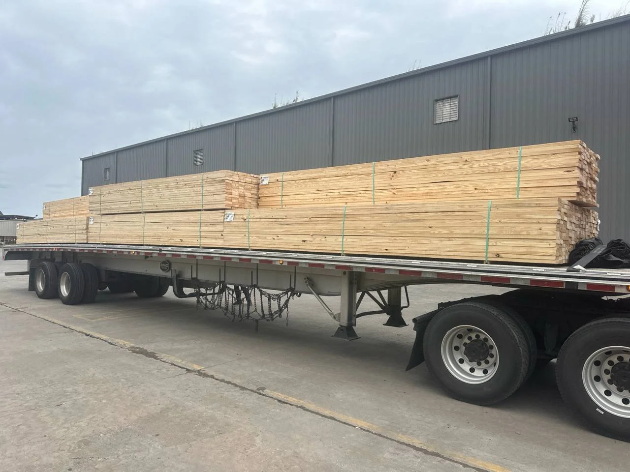 flatbed truck with lumber on the back.