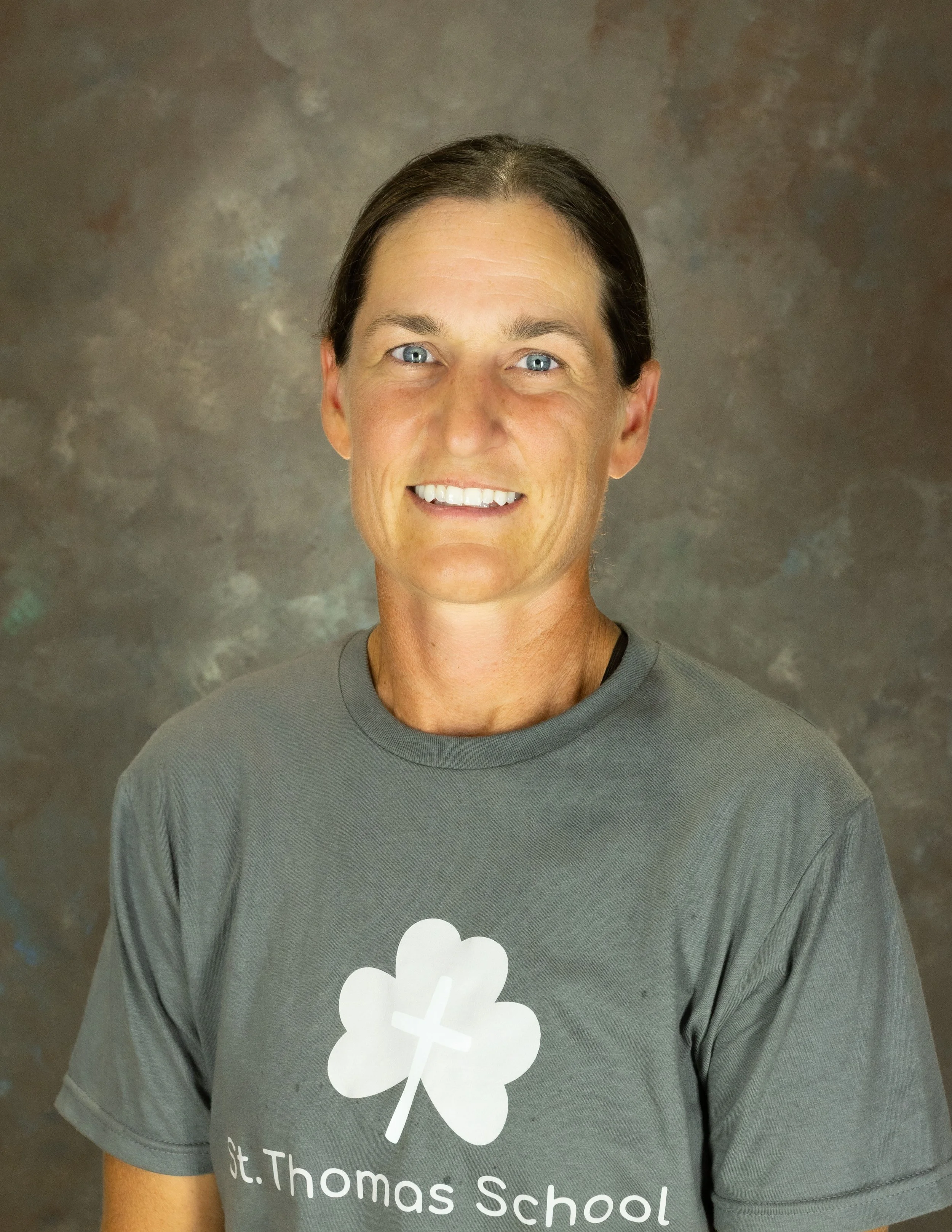 Woman in STS shirt smiling at camera.