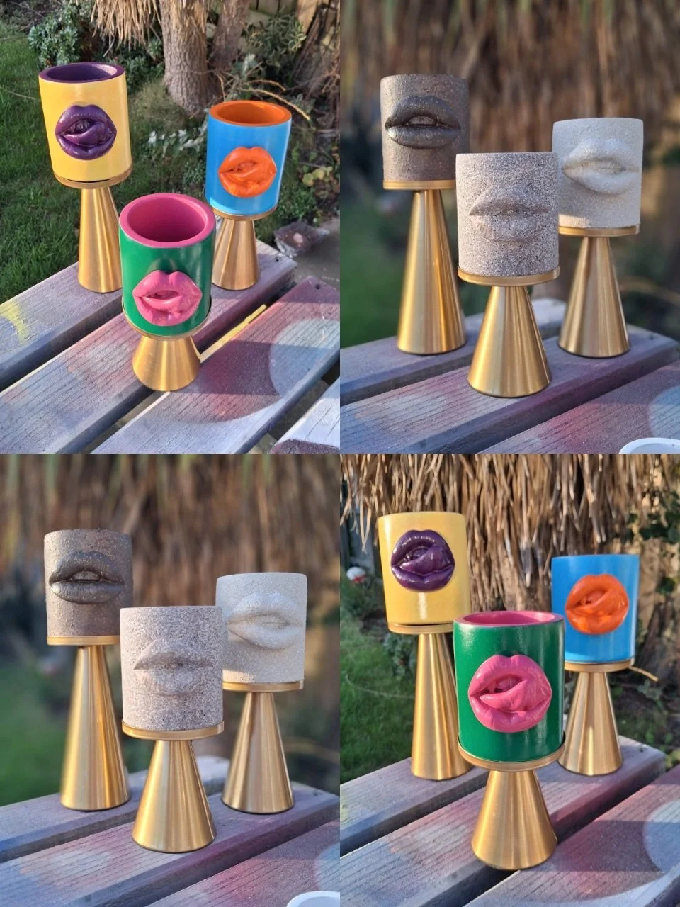Four colorful cups with lips designs on a wooden table, and four stone carvings of lips on stands, arranged outdoors.