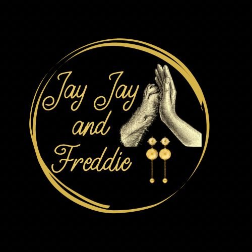 Logo with gold circular border, featuring the text "Jay Jay and Freddie," two illustrated hands in a high-five or prayer position, and a pair of gold earrings on a black background.