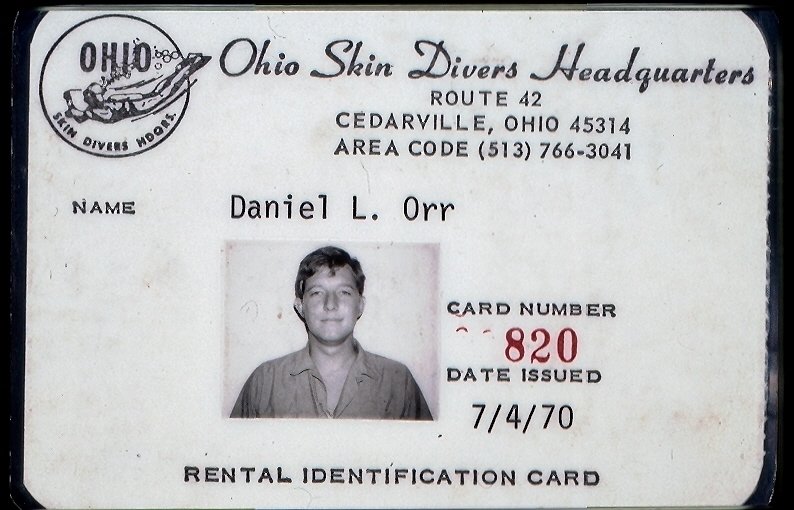 Rental identification card for Ohio Skin Divers Headquarters. It features the name Daniel L. Orr, card number 820, issued on July 4, 1970. The card has a black and white photo of a young man and a logo of a diver with the text "Ohio Skin Divers". The