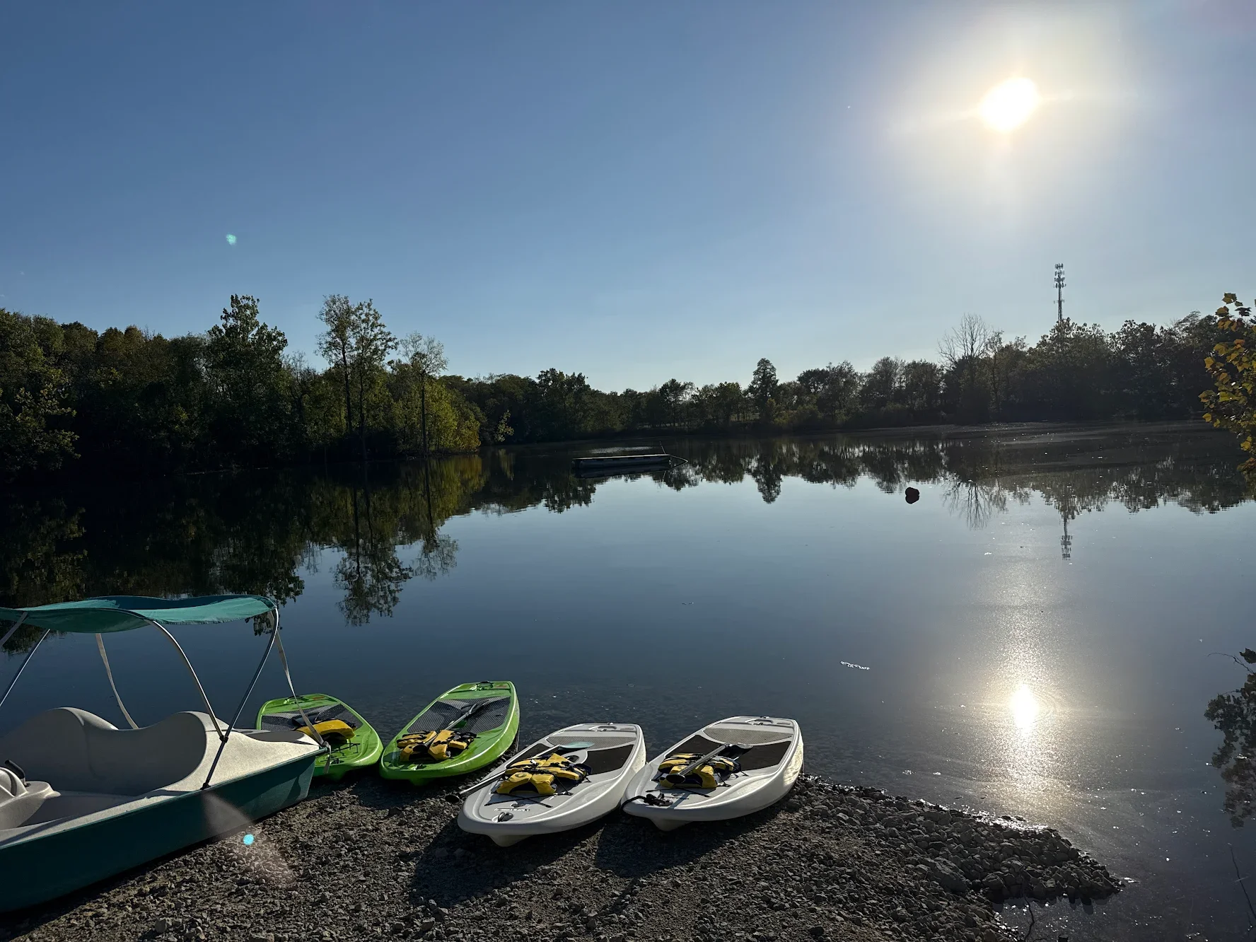 Paddleboards and pedal boat ready on the shore at Silver Cup Lake Adventures in Ohio