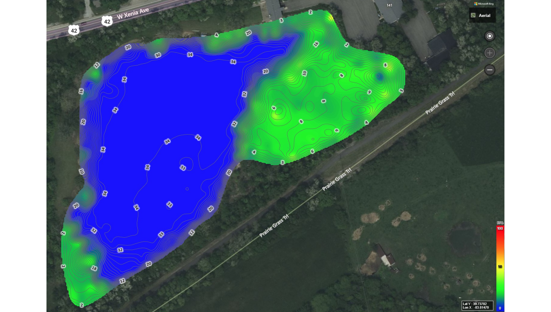 Aerial map showing a pond with depth contours in blue, indicating deeper areas, and surrounding land with green areas representing shallower regions. The map includes street labels for West Xenia Avenue and Prairie Grass Trail.
