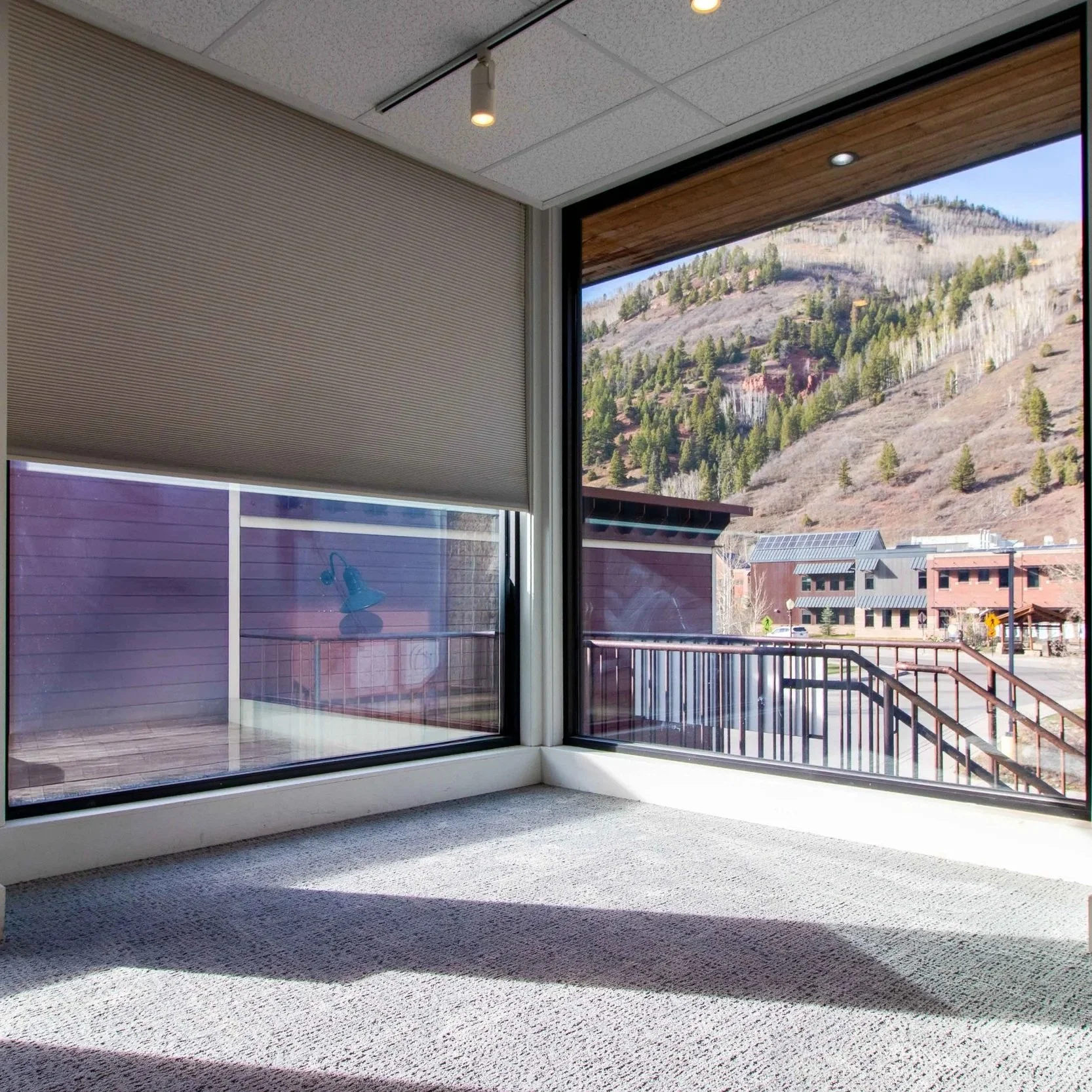 Minimalist illustration of a building with geometric shapes, featuring blue tones and arched windows.