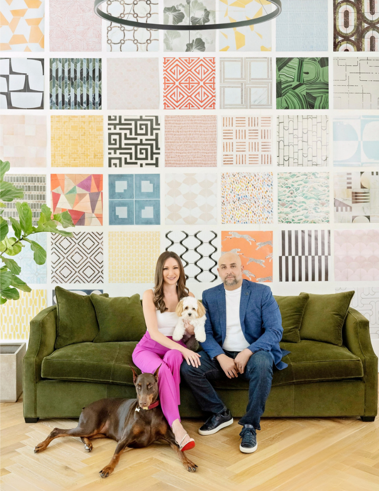 Paula and Gustavo Gamboa with their dogs on a green sofa