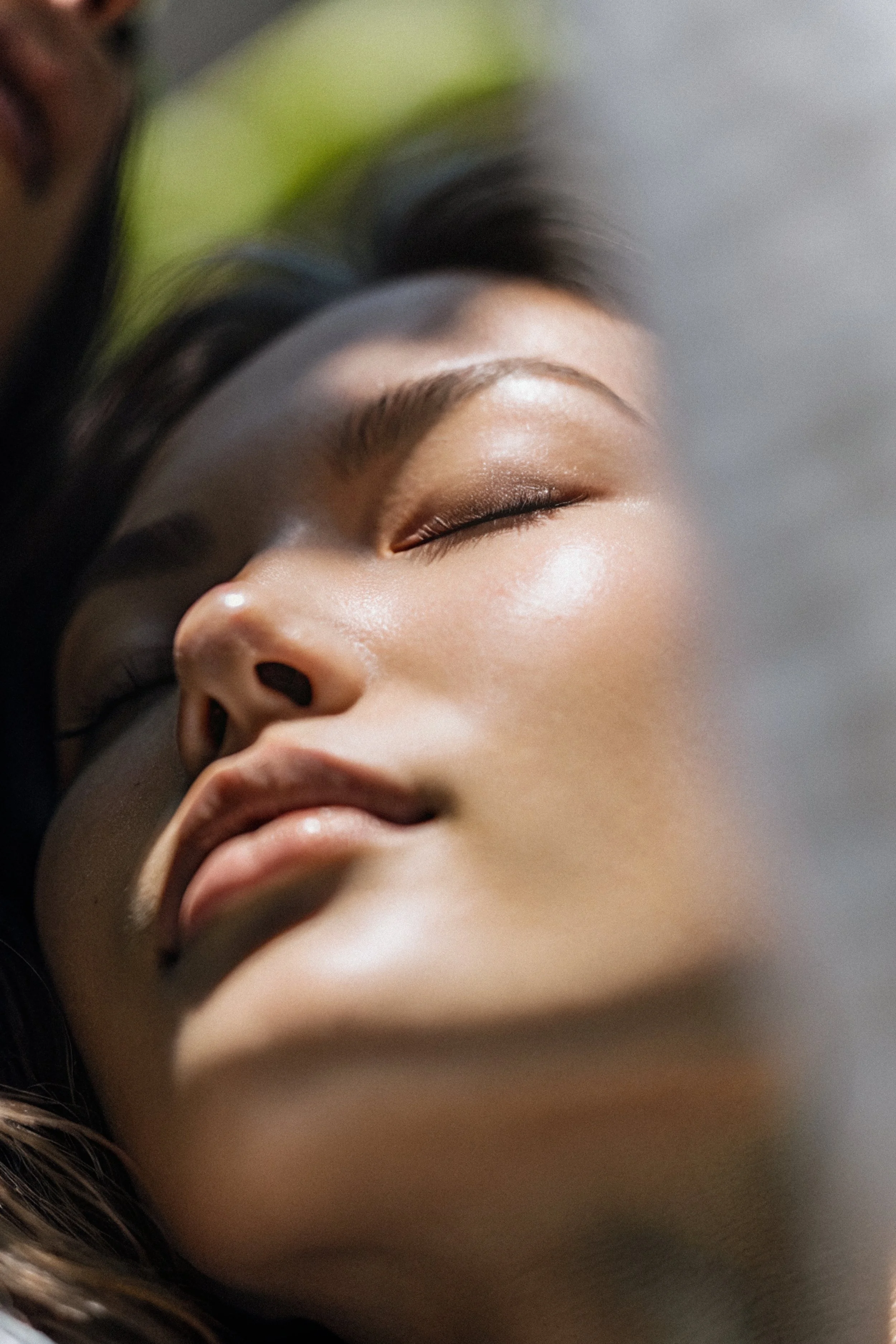 Close-up of a woman with closed eyes, peacefully sleeping, with smooth skin and makeup.