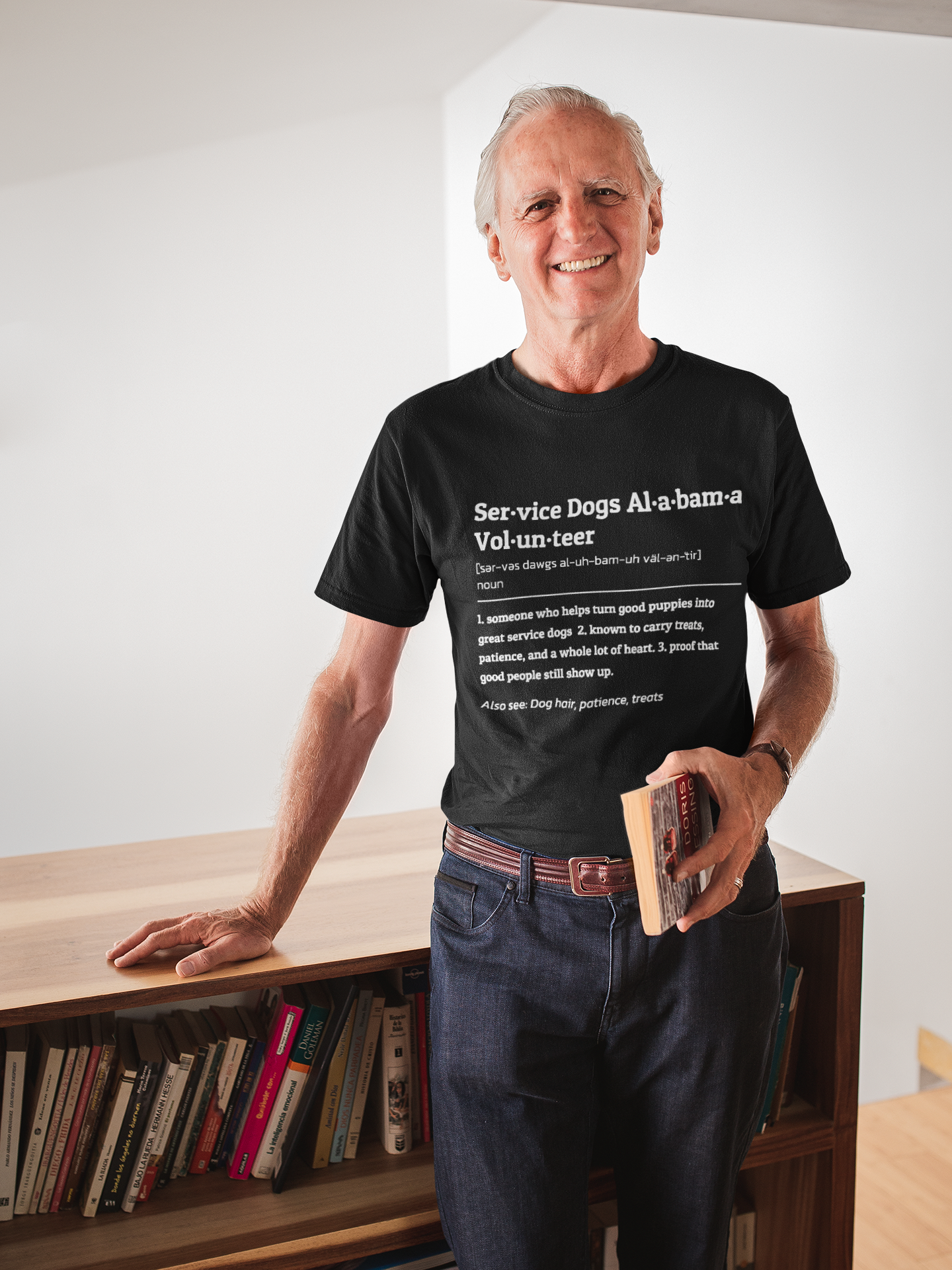 smiling-man-wearing-a-tshirt-mockup-holding-a-book-in-his-house-a20506.png