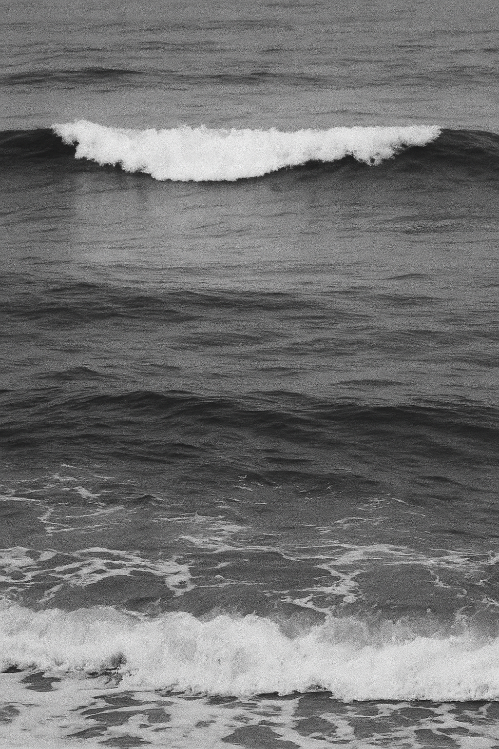black and white photo of a wave in the ocean
