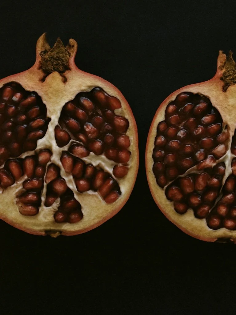 pomegranate halves on a black background